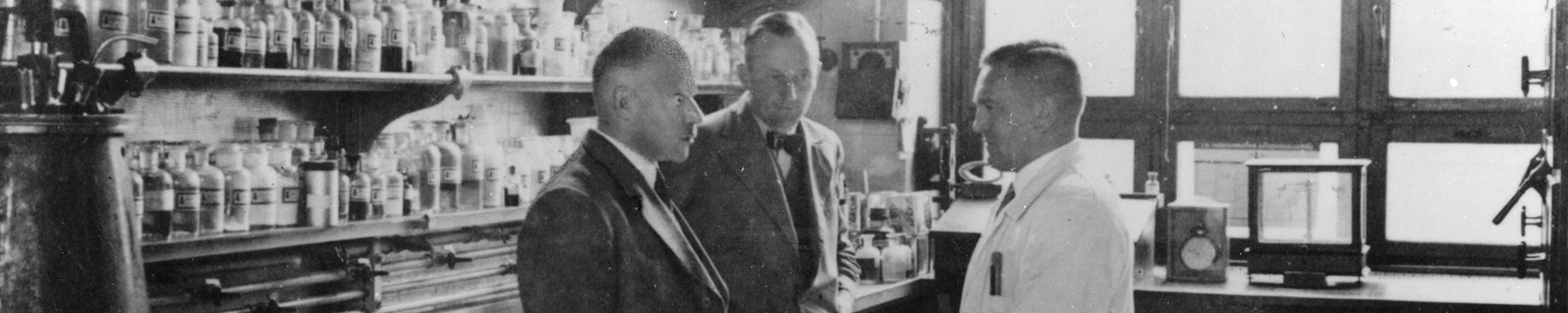 Original picture from the Bayer archives of Dr Hans Finkelstein conversing with colleagues in a laboratory at the Uerdingen site of I.G. Farben, recorded in 1932.